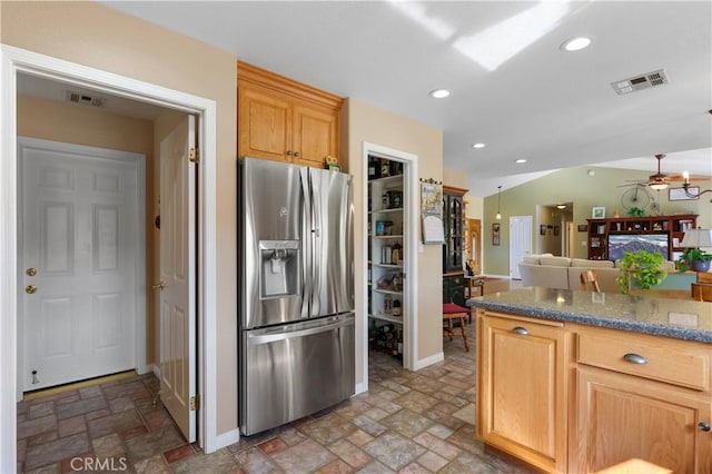 23220 Lakeview Dr, Tehachapi, CA 93561 - kitchen with stainless steel fridge, a ceiling fan, light stone finish floors, recessed lighting, and dark stone countertops