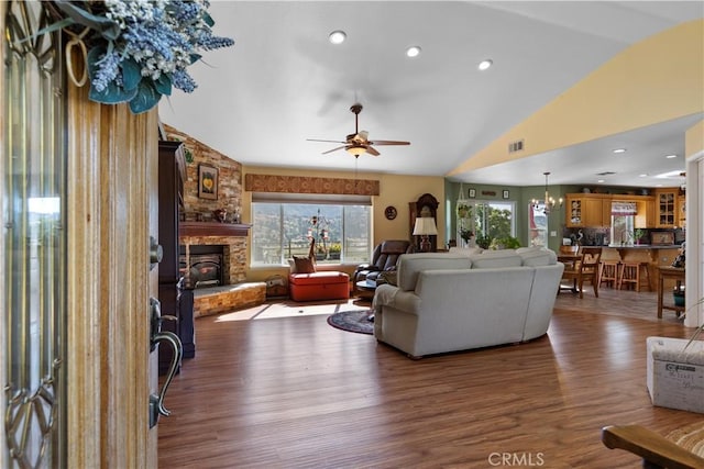 23220 Lakeview Dr, Tehachapi, CA 93561 - living area featuring vaulted ceiling, wood finished floors, a ceiling fan, a stone fireplace, and a chandelier
