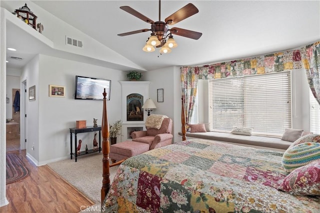 23220 Lakeview Dr, Tehachapi, CA 93561 - bedroom with vaulted ceiling, wood finished floors, a fireplace, and ceiling fan