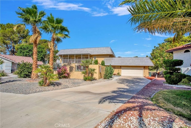 15037 Wildflower Ln, Helendale, CA 92342 - view of front of property featuring driveway, stucco siding, and a garage