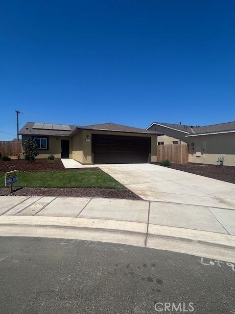 781 Brent Ct, Merced, CA 95341 - ranch-style home with an attached garage, solar panels, driveway, and stucco siding
