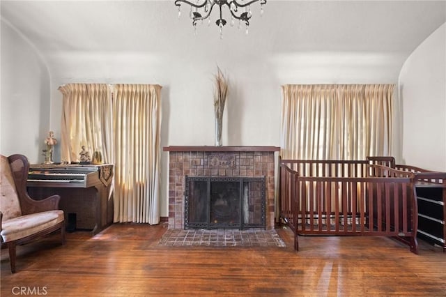 1636 W 70th St, Los Angeles, CA 90047 - living area featuring wood finished floors, a chandelier, and a tile fireplace