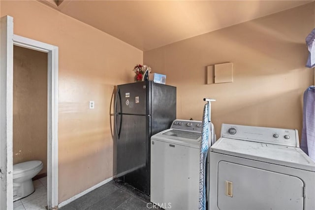 1636 W 70th St, Los Angeles, CA 90047 - laundry area featuring washer and clothes dryer and tile patterned floors