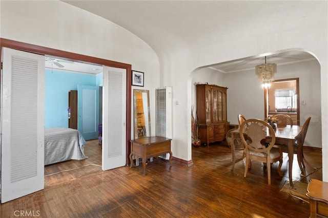 1636 W 70th St, Los Angeles, CA 90047 - dining space with arched walkways, a chandelier, wood finished floors, and a heating unit