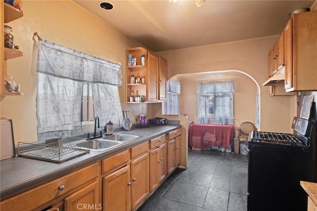 1636 W 70th St, Los Angeles, CA 90047 - kitchen featuring black range with gas cooktop, open shelves, arched walkways, under cabinet range hood, and brown cabinetry