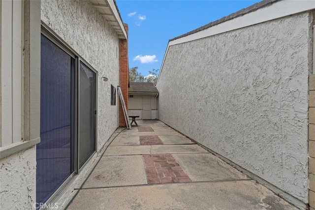 5081 Blackpool Rd, Westminster, CA 92683 - view of side of home featuring stucco siding and a patio area