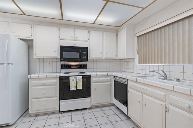 5081 Blackpool Rd, Westminster, CA 92683 - kitchen featuring black microwave, freestanding refrigerator, electric range, dishwashing machine, and backsplash