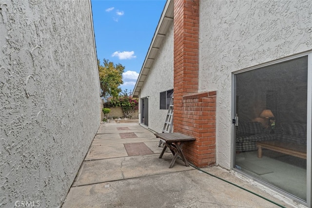 5081 Blackpool Rd, Westminster, CA 92683 - view of side of home featuring stucco siding, a chimney, and a patio area
