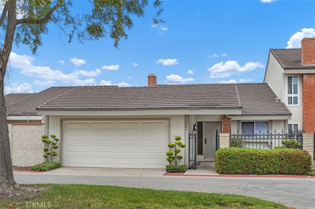 5081 Blackpool Rd, Westminster, CA 92683 - view of front of house with a chimney, a garage, and driveway