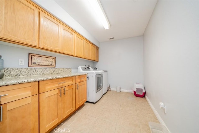 8225 Ailanthus St, Phelan, CA 92371 - laundry room featuring washing machine and clothes dryer, cabinet space, and light tile patterned floors