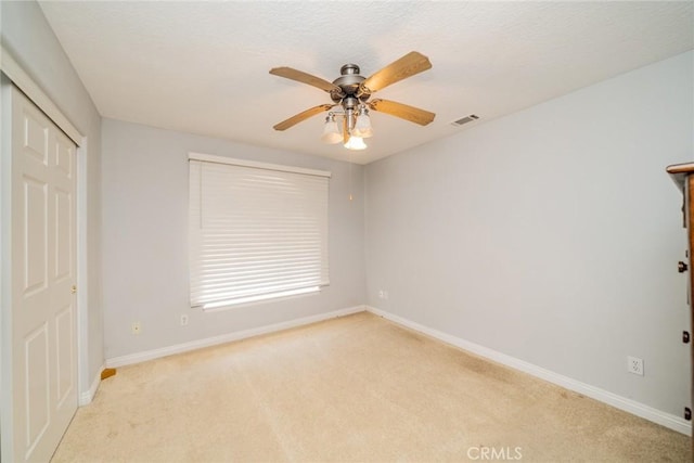 8225 Ailanthus St, Phelan, CA 92371 - unfurnished bedroom featuring light colored carpet, a closet, and a ceiling fan