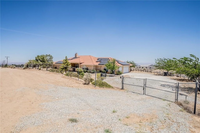 8225 Ailanthus St, Phelan, CA 92371 - view of yard with a gate, concrete driveway, and an attached garage