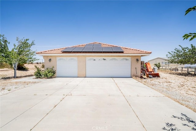 8225 Ailanthus St, Phelan, CA 92371 - view of front facade featuring solar panels, stucco siding, a garage, and a tiled roof