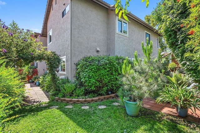 247 Currant Way, Oceanside, CA 92057 - view of home's exterior featuring stucco siding and a yard
