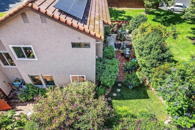 247 Currant Way, Oceanside, CA 92057 - view of side of property featuring stucco siding, roof mounted solar panels, and a tiled roof