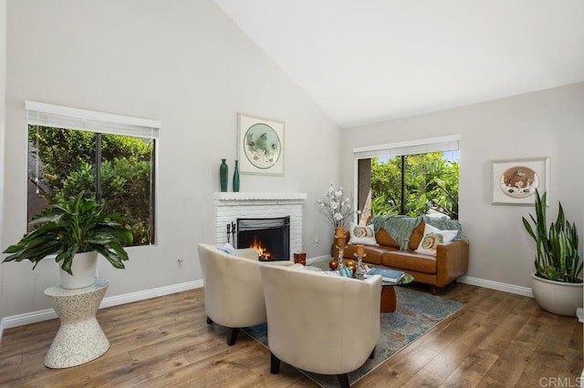 247 Currant Way, Oceanside, CA 92057 - living area with high vaulted ceiling, healthy amount of natural light, wood finished floors, and a brick fireplace