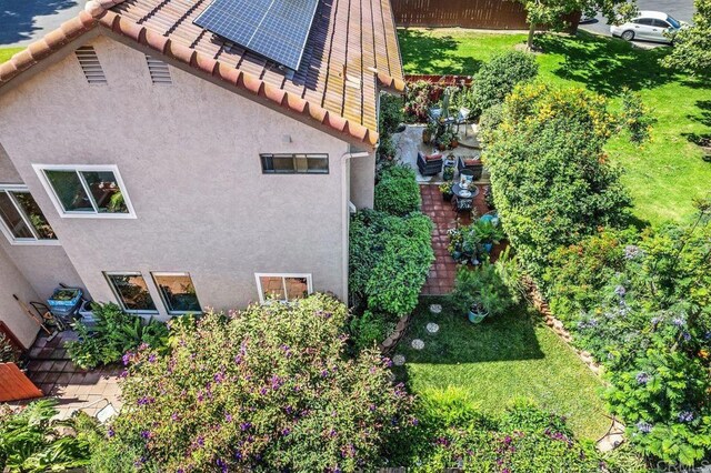 247 Currant Way, Oceanside, CA 92057 - view of side of property with stucco siding, roof mounted solar panels, and a tile roof