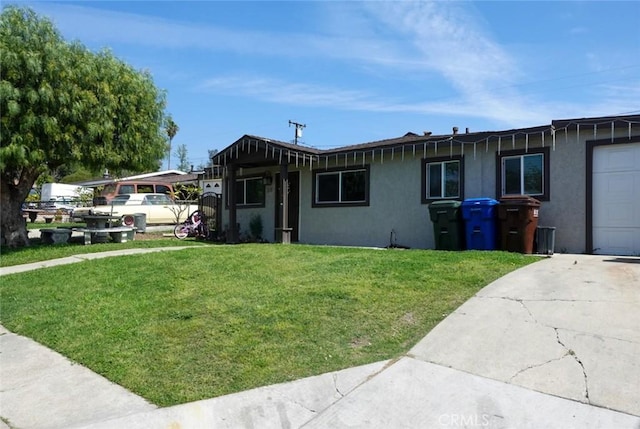 318 Lochmere Ave, La Puente, CA 91744 - view of front of property featuring stucco siding, a front yard, and concrete driveway