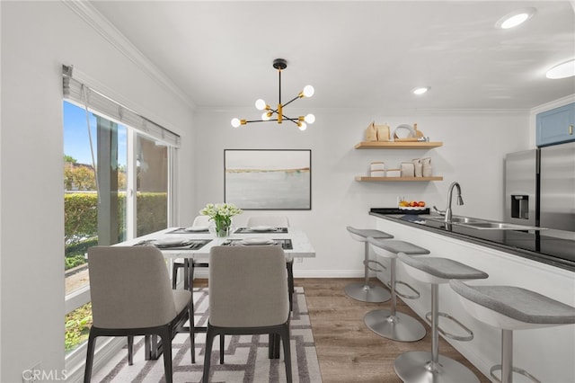 1001 W Stevens Ave Unit 184, Santa Ana, CA 92707 - dining room featuring healthy amount of natural light, crown molding, a chandelier, wood finished floors, and recessed lighting