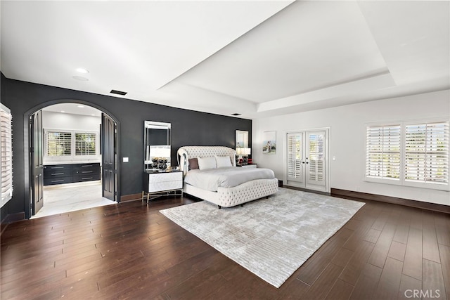 30372 Marbella Vis, San Juan Capistrano, CA 92675 - bedroom with arched walkways, access to exterior, a raised ceiling, dark wood-type flooring, and recessed lighting