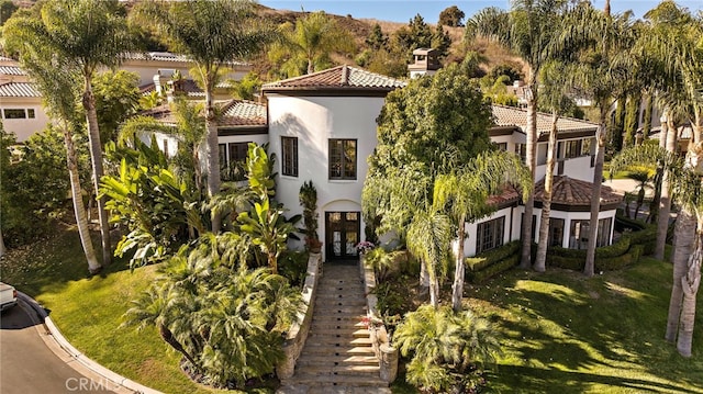 30372 Marbella Vis, San Juan Capistrano, CA 92675 - mediterranean / spanish home with stucco siding, a tiled roof, a front yard, and stairway