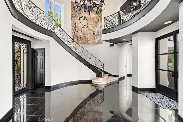 30372 Marbella Vis, San Juan Capistrano, CA 92675 - foyer entrance featuring a chandelier, a towering ceiling, and arched walkways