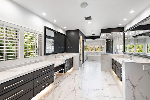 30372 Marbella Vis, San Juan Capistrano, CA 92675 - bathroom with two vanities, a soaking tub, healthy amount of natural light, and recessed lighting