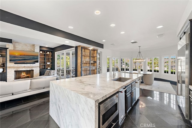 30372 Marbella Vis, San Juan Capistrano, CA 92675 - kitchen featuring granite floors, stainless steel microwave, healthy amount of natural light, and recessed lighting