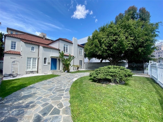 667 S Bronson, Los Angeles, CA 90005 - view of front of home with a tile roof, stucco siding, and a chimney