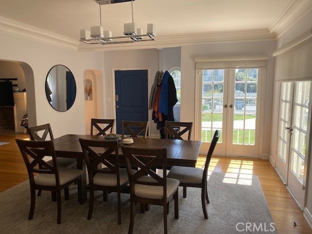 667 S Bronson, Los Angeles, CA 90005 - dining area with crown molding, light wood finished floors, french doors, and arched walkways