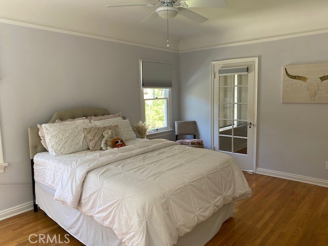 667 S Bronson, Los Angeles, CA 90005 - bedroom with wood finished floors, ornamental molding, and ceiling fan