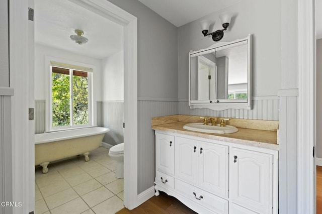 7950 Flynn Creek Rd, Comptche, CA 95427 - bathroom with a freestanding tub, wainscoting, vanity, and tile patterned flooring