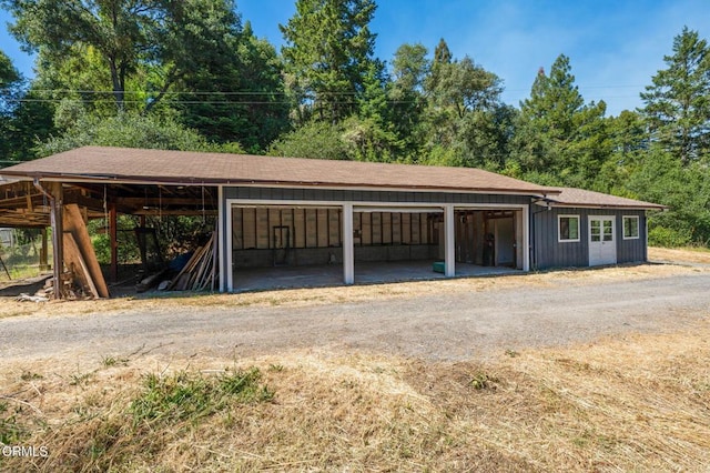 7950 Flynn Creek Rd, Comptche, CA 95427 - garage featuring dirt driveway and a carport
