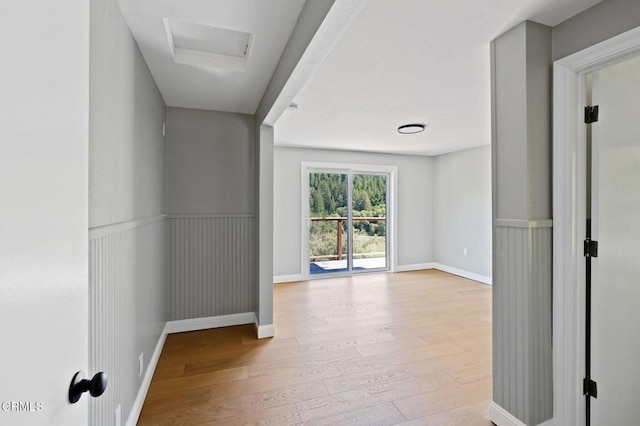 7950 Flynn Creek Rd, Comptche, CA 95427 - hall featuring wood-type flooring, wainscoting, and attic access