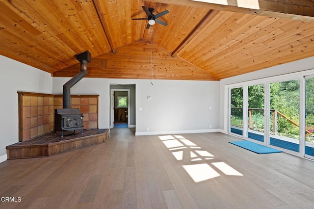 7950 Flynn Creek Rd, Comptche, CA 95427 - unfurnished living room with ceiling fan, a wood stove, a wooden ceiling with exposed beams, high vaulted ceiling, and wood-type flooring