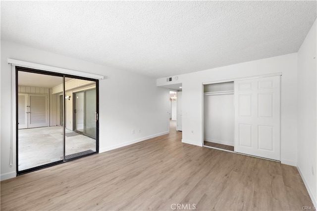 31291 E Nine Dr Unit 29F, Laguna Niguel, CA 92677 - unfurnished bedroom featuring wood finished floors, a closet, a textured ceiling, and access to outside
