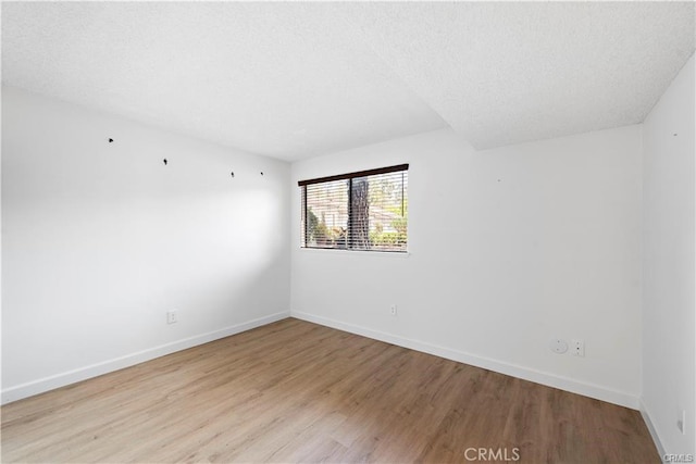 31291 E Nine Dr Unit 29F, Laguna Niguel, CA 92677 - empty room with wood finished floors and a textured ceiling
