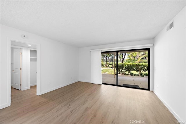 31291 E Nine Dr Unit 29F, Laguna Niguel, CA 92677 - empty room with light wood-type flooring and a textured ceiling