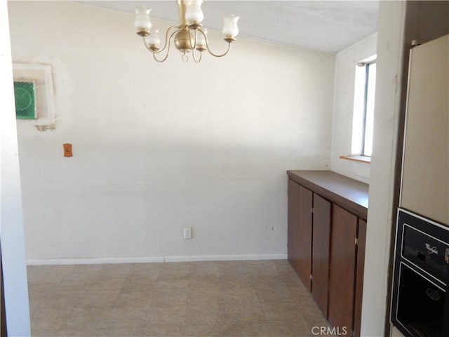 3250 Apple Ave, Jurupa Valley, CA 92509 - unfurnished dining area featuring a chandelier and baseboards