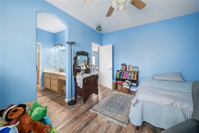 1681 Ocean St, Oceano, CA 93445 - bedroom featuring wood finished floors, arched walkways, ceiling fan, and connected bathroom