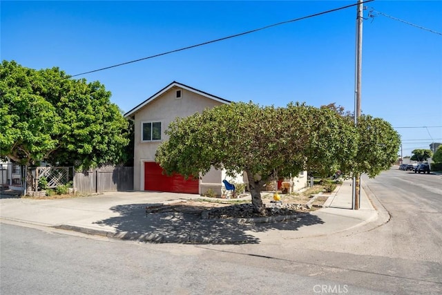 1681 Ocean St, Oceano, CA 93445 - view of property hidden behind natural elements with an attached garage, concrete driveway, and stucco siding