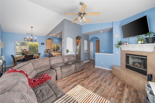 1681 Ocean St, Oceano, CA 93445 - living room featuring a chandelier, wood finished floors, vaulted ceiling, a high end fireplace, and ceiling fan