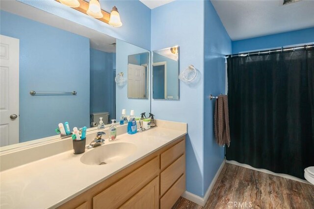 1681 Ocean St, Oceano, CA 93445 - full bath featuring wood finished floors, vanity, and a shower with shower curtain