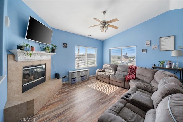 1681 Ocean St, Oceano, CA 93445 - living area with lofted ceiling, ceiling fan, wood finished floors, and a tiled fireplace