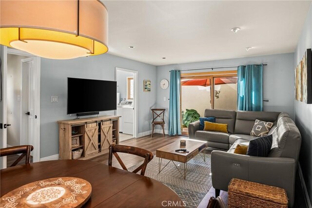 24 Spicewood Way, Irvine, CA 92612 - living room featuring washer / dryer and wood finished floors