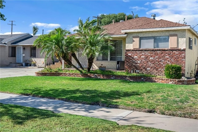 9513 Rex Rd, Pico Rivera, CA 90660 - view of front of house featuring stucco siding, a front lawn, driveway, and brick siding