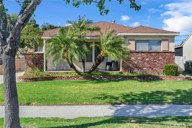 9513 Rex Rd, Pico Rivera, CA 90660 - view of front of house featuring brick siding, a front lawn, and stucco siding