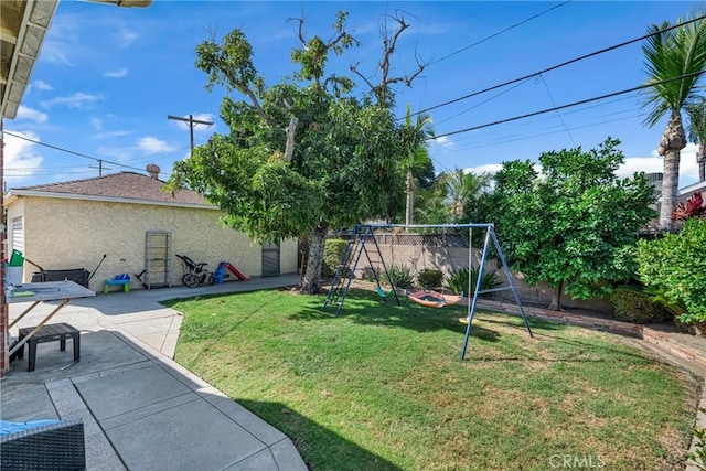 9513 Rex Rd, Pico Rivera, CA 90660 - fenced backyard featuring a playground and a patio area