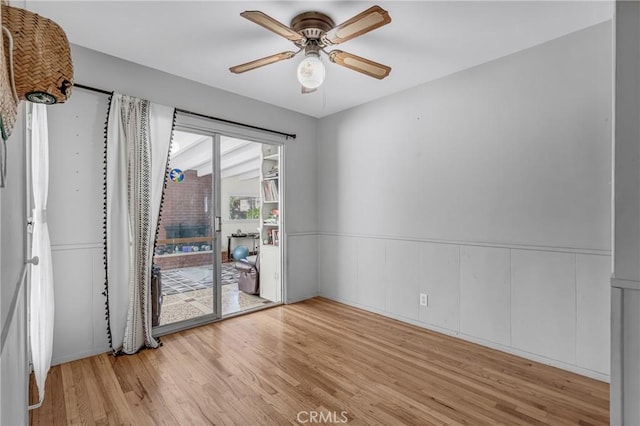 9513 Rex Rd, Pico Rivera, CA 90660 - unfurnished room with light wood-style floors, ceiling fan, and wainscoting