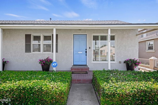 324 N J St, Oxnard, CA 93030 - view of exterior entry featuring a porch and stucco siding